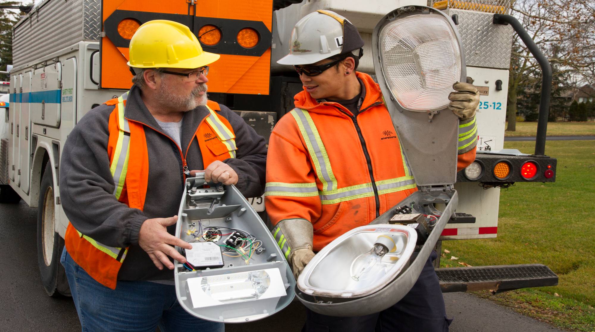 Two men analysing a street light